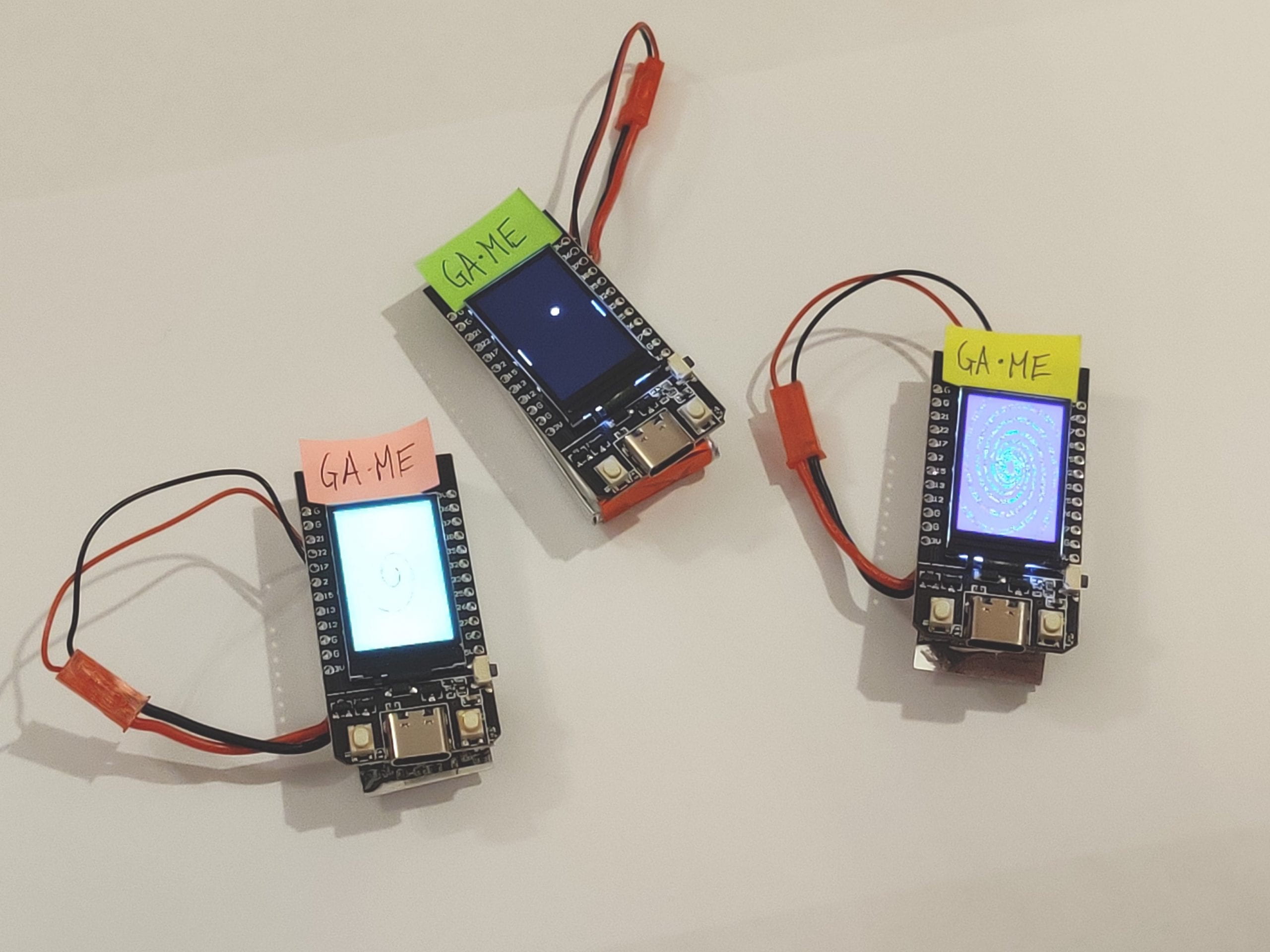Photo of the three Ga-Me devices showing the Pong and generative art components